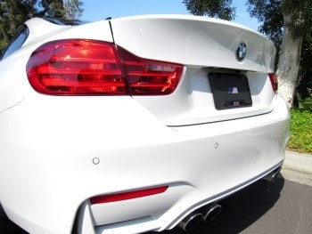 Finished white BMW rear bumper after scratch repair